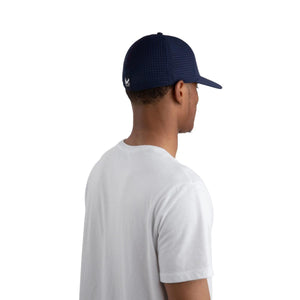 Person wearing a navy blue perforated Mission baseball cap from the side