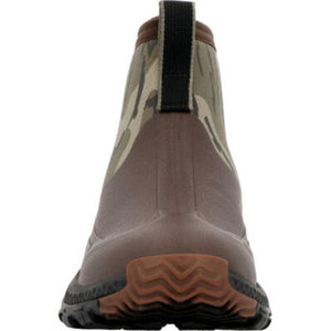 Back view of Muck camo ankle boot with brown rubber heel and textured sole