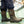 Person wearing brown Muck Chore Cool rubber boots with dark blue work pants