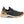 Muck black and tan athletic sneaker with a textured knit upper and rubber sole