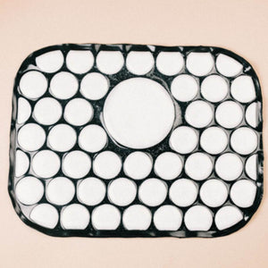Onyx Cool rectangular mat with a black grid pattern and white circular cutouts