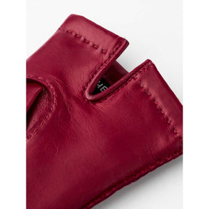 Close up of red leather glove cuff with visible stitching