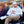 Man wearing ExtremeMIST hoodie and cap sitting in a folding chair holding a patterned mug