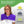 Woman wearing purple Nature Creation herbal neck wrap showing heat cold and aromatherapy icons