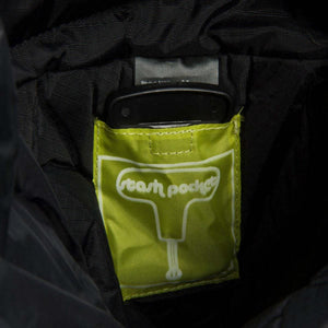 Neos stash pocket label on lime green fabric inside a black bag