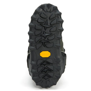 Neos boot tread showing black rubber lugged sole with yellow Vibram logo