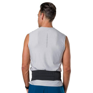 Man wearing a grey Nathan sleeveless shirt and a black running belt from behind