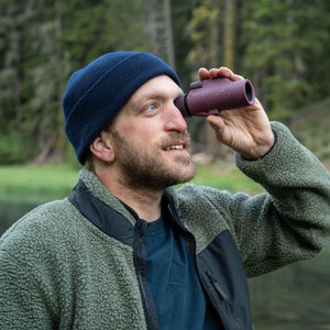 Person wearing a beanie using a NOCS Provisions monocular outdoors