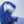 Blue handheld misting fan spraying water