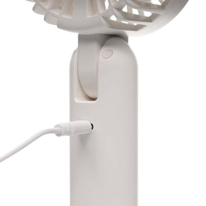 Treva portable fan charging with a white USB cable