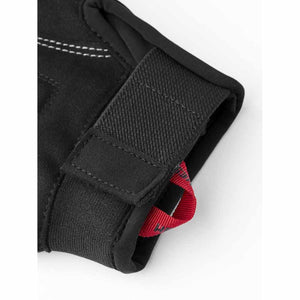 Black glove cuff with adjustable velcro strap and red pull tab