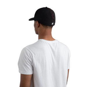 Back view of a person wearing a black perforated Mission baseball cap