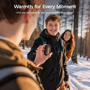 Person holding an Ocoopa UT3 Lite hand warmer in a snowy forest
