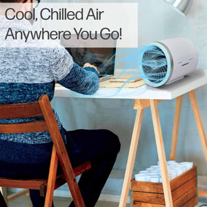 Ontel portable desk fan blowing air on a person working at a laptop