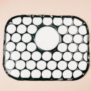 Onyx Cool rectangular mat with a black grid pattern and white circular cutouts
