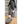 Person wearing grey cable knit ActionHeat slippers while sitting on carpeted stairs
