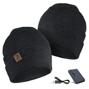 Two black ActionHeat knit beanies with a power bank and USB charging cable