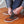 Person adjusting ActionHeat heated brown leather boots with visible internal heating elements
