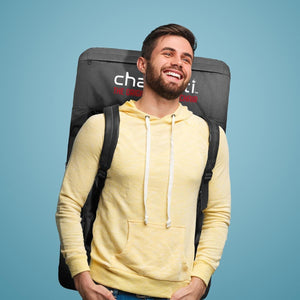 Man wearing a yellow hoodie carrying a Chaheati branded backpack chair