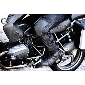 Rider wearing Gerbing black textile motorcycle pants with knee armor on a BMW GS motorcycle