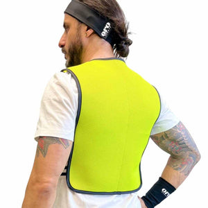 Man wearing a neon yellow Oro Sports mesh vest over a white t-shirt