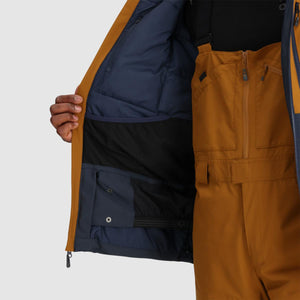 Interior view of an open brown ski jacket showing navy blue lining and mesh pockets over matching brown ski bibs