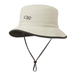 Outdoor Research cream bucket hat with dark brim and adjustable chin strap
