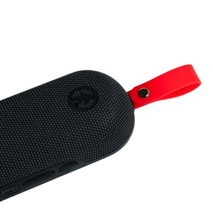 Outdoor Tech black portable speaker with red silicone strap