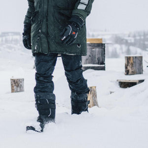 Person wearing Baffin winter boots and outdoor gear walking in deep snow