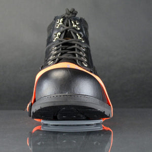 Winter Walking ice cleat attached to the front of a black work boot