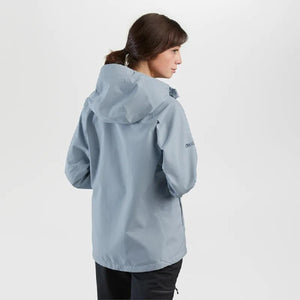 Woman wearing a light blue Outdoor Research hooded rain jacket viewed from the back