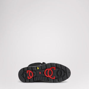 Black Pajar boot sole with red ice grip hardware