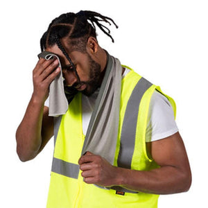 Worker in high visibility vest wiping forehead with grey cooling towel