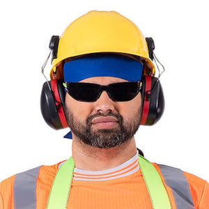 Pioneer worker wearing a yellow hard hat, blue headband, black sunglasses, and ear muffs over an orange safety vest