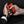 Person holding an orange and black ActionHeat portable hand warmer