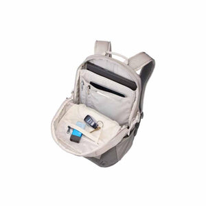 Open Thule backpack showing interior laptop sleeve and organizer pockets with keys and accessories