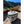 Polar Bear soft cooler on a sandy riverbank with wooden boats in the background