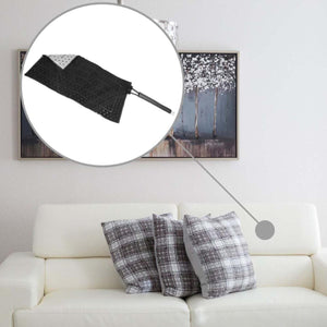 Black microfiber duster head with handle shown above a white sofa with plaid cushions
