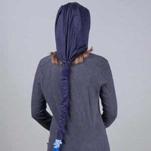 Person wearing a navy blue ponytail hood accessory over a grey long sleeve shirt