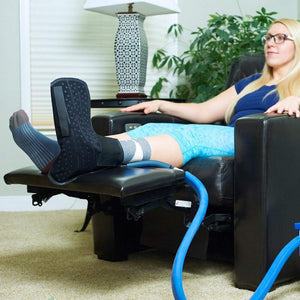 Polar Products cold therapy ankle wrap on a person sitting in a recliner