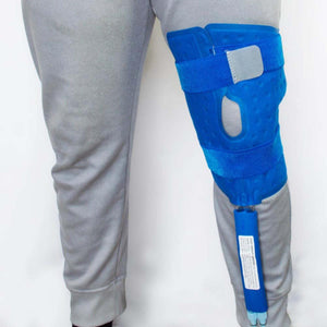 Polar Products blue cold therapy knee wrap secured with velcro straps on a person wearing grey sweatpants