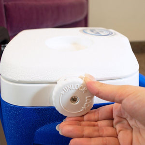 Hand turning the white lock dial on a blue and white Polar Products cooler