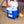 Person placing water bottle into a blue Polar Products cold therapy cooler