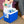 Person placing a water bottle into a blue Polar Products cooler