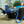 Man resting in a recliner with a blue cold therapy foot wrap connected to a cooling system
