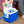 Person placing a plastic water bottle into a blue Polar cooler