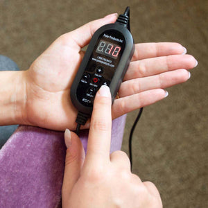 Hand holding a Polar Products digital controller with time and power settings