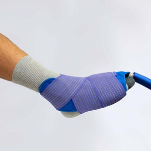 Foot wearing a grey sock with a blue ice pack secured by a purple elastic compression wrap