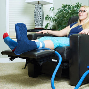 Polar Products cold therapy foot wrap worn by a person sitting in a recliner
