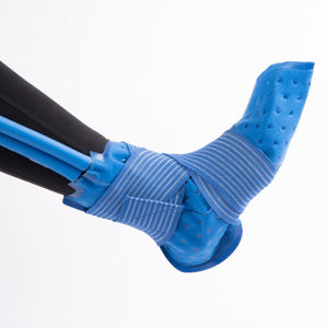 Polar Products blue ankle cold therapy wrap secured with elastic straps on a person wearing black leggings